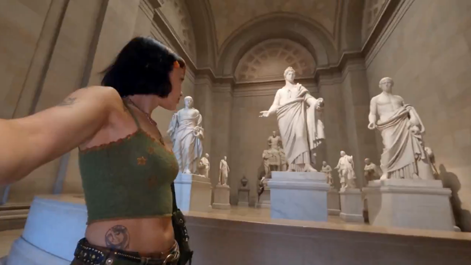 Claudia in a sculpture gallery, arm extended toward marble statues